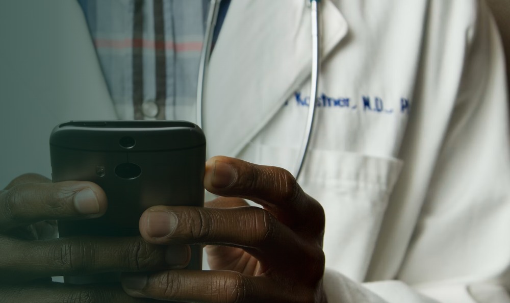 A doctor holding a smartphone
